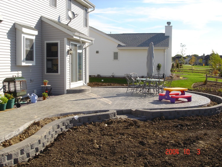 Curved paver patio with seating area
