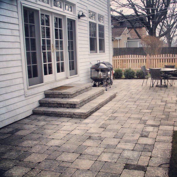 Brick paver patio with stone steps