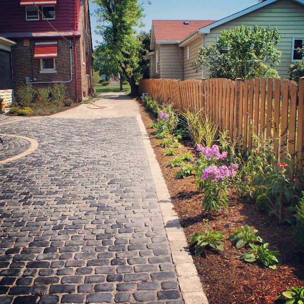 Cobblestone driveway with flower border